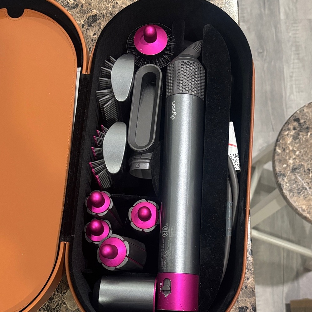 Dyson multi-attachment styler in charcoal and hot pink